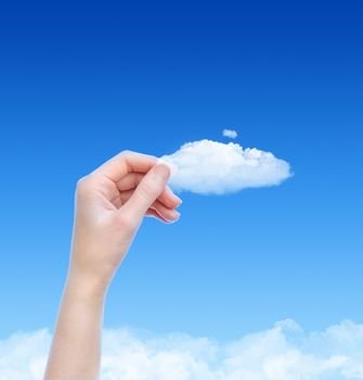 Woman hand hold the cloud against blue sky with clouds. Concept image on cloud computing and eco theme with copy space.