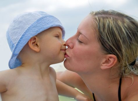 Young mother kissing her little child