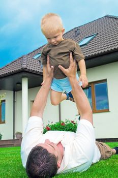 Father having fun with a baby in yard