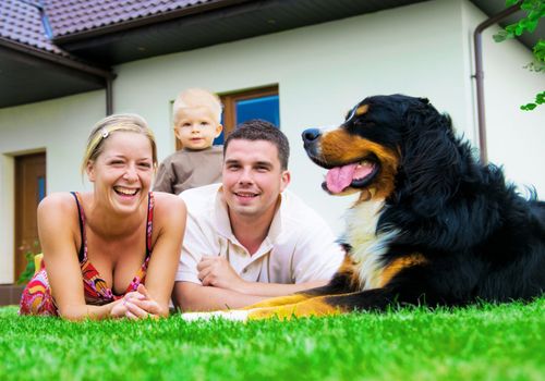 Happy family in front of their house