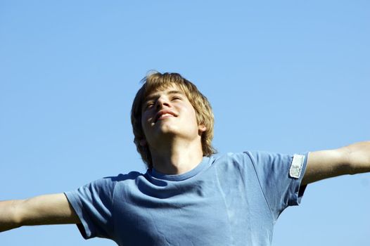 In tune with nature. Young boy showing happiness