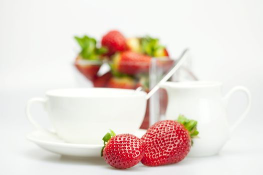 juicy strawberries and tableware isolated on white
