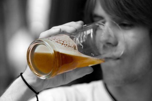 Teenager drinking beer. Black and white