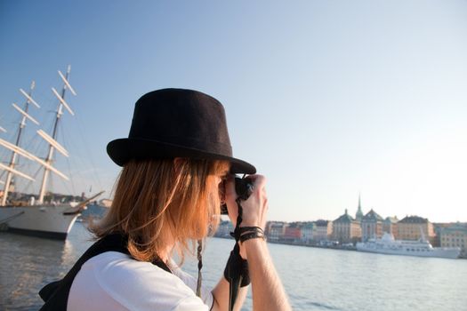 A photographer artist taking pictures of waterfront of Stockholm, Sweden