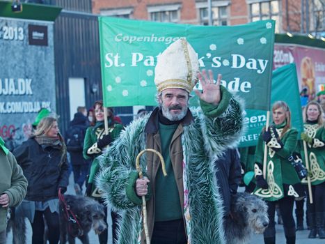 COPENHAGEN - MAR 17: Man acting as St. Patrick and other participants at the annual St. Patrick's Day celebration and parade in front of Copenhagen City Hall, Denmark on March 17, 2013.
