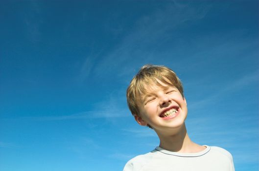 Happy boy on sky background