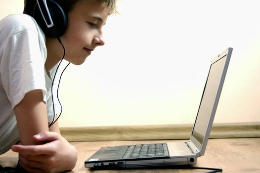 Boy spending time with notebook and modern technology