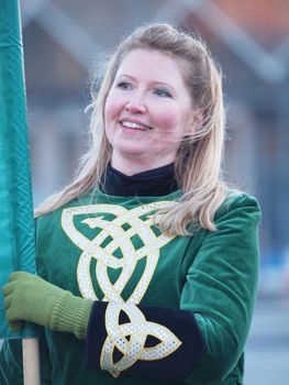 COPENHAGEN - MAR 17: Woman participant in green costume at the annual St. Patrick's Day celebration and parade in front of Copenhagen City Hall, Denmark on March 17, 2013.