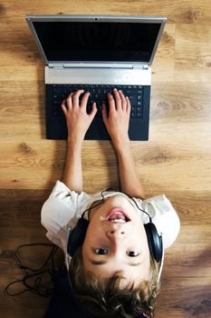 Boy spending time with notebook and modern technology