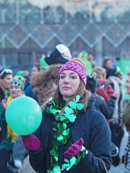 COPENHAGEN - MAR 17: Woman spectator at the annual St. Patrick's Day celebration and parade in front of Copenhagen City Hall, Denmark on March 17, 2013.