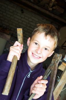 Young boy playing in garage with tools