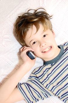 Teen boy relax by talking on cell phone