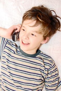 Teen boy relax by talking on cell phone