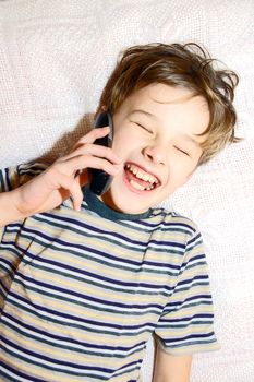 Teen boy relax by talking on cell phone