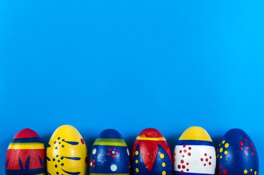 Easter colored eggs on blue background