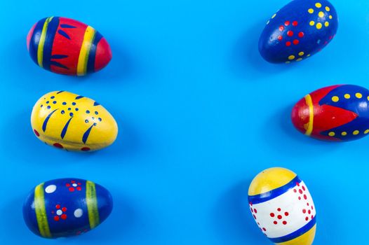 Easter colored eggs on blue background