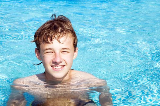 Happy smiling boy in a pool