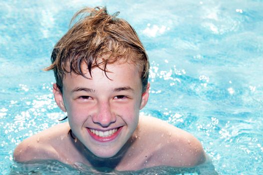 Happy laughing boy in a pool