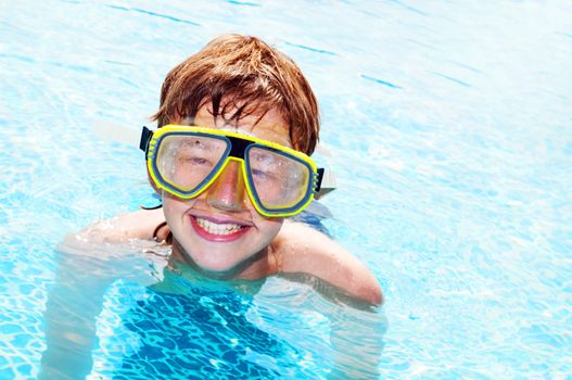 Happy laughing boy in a pool