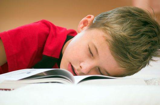 Young boy fell asleep after hard studying