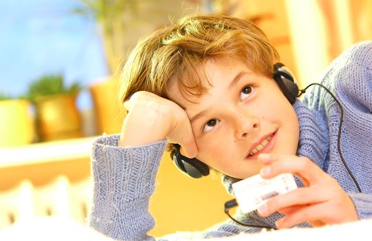 Boy listen to music in warm sunny bedroom