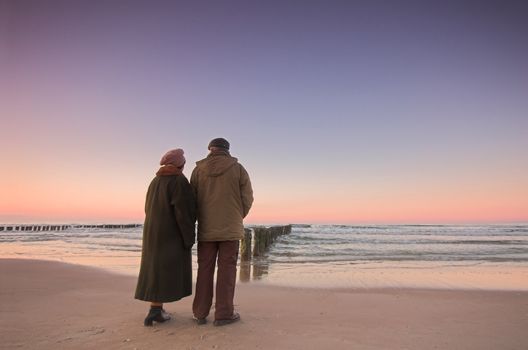 Beautiful ocean sunset and seniors' love