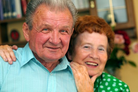 Elderly happy couple in a room