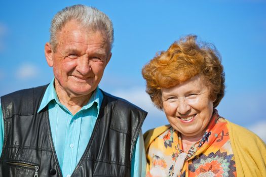 Happy senior couple together in love, outside, blue sky