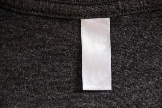 A dark gray shirt and a white label.
