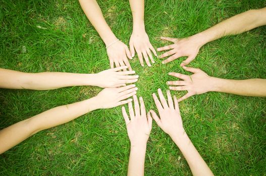 Group of friends joining hands. Unity, teamwork concept