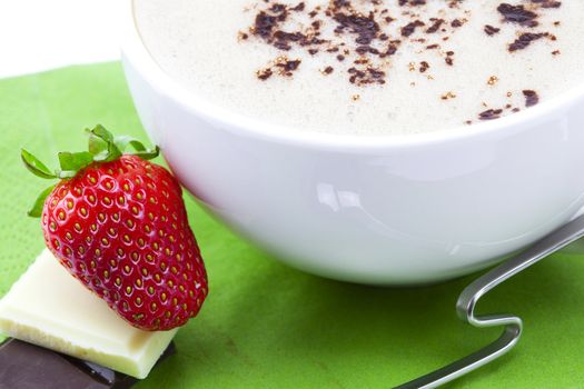 cappuccino, strawberry and chocolate on a napkin