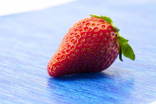 Strawberries on blue paper