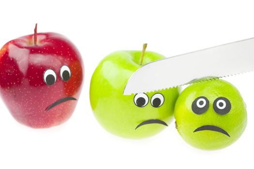 comic still life of apples and limes with eyes isolated on white