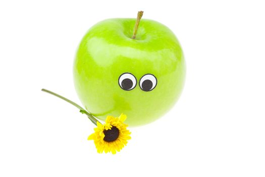 apple with eyes and a flower isolated on white