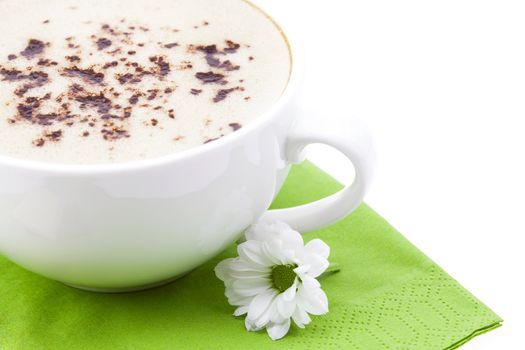 cup of cappuccino and a flower on a napkin