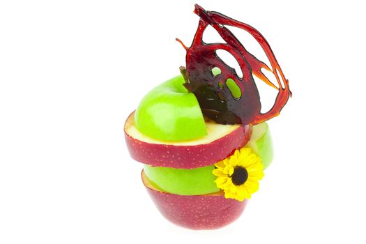 sliced apples with caramel and a flower isolated on white