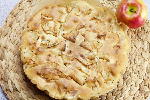 home apple pie and apple on a wicker mat