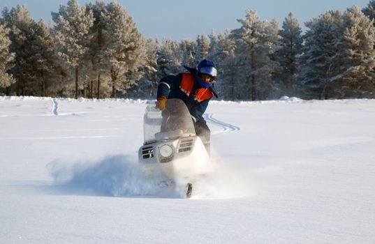 Snowmobile at full speed. Winter landscape.