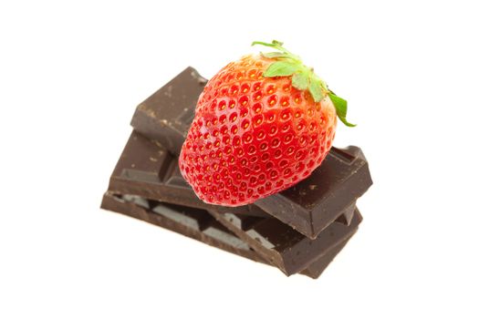 Strawberry on the mountain of chocolate isolated on white