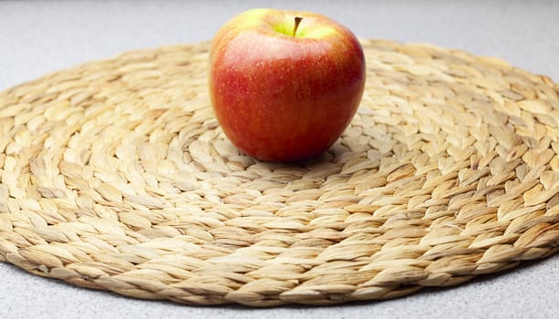 apple on a wicker mat