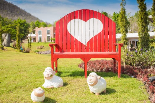 Green grass and heart shape on bench in the garden
