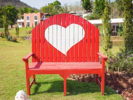Green grass and heart shape on bench in the garden