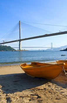 boat on the beach under the bridge