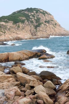 rocky sea coast and blurred water in shek o,hong kong 