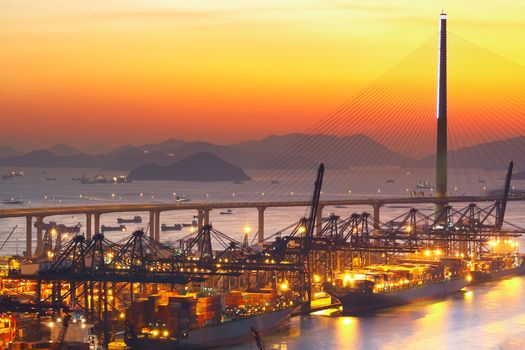 Port warehouse with cargoes and containers at sunset 