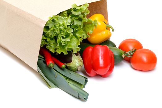 grocery bag full of vegetables isolated on white background