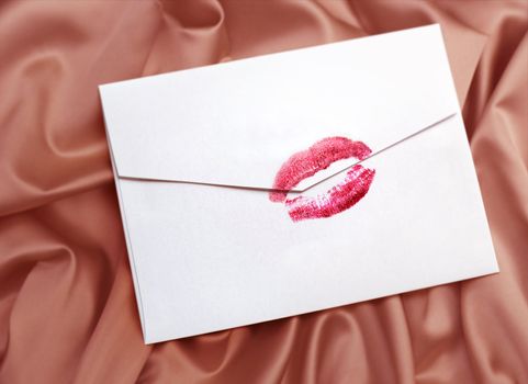 white envelope with lipstick kiss on gentle silk