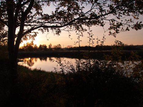 Beautiful dramatic sunset over a small countryside rural lake