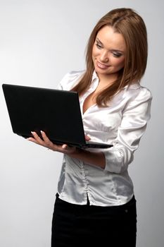 Young and beautiful girl in a light shirt with a black notebook in hand