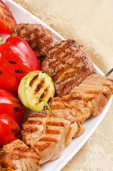 BBQ meat with vegetables and greens closeup